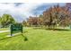 Huston Lake Park's lush green lawn with shady trees and walking path on a beautiful, sunny day at 970 S Canosa Ct, Denver, CO 80219