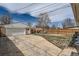 Spacious backyard with a detached garage, grassy area, and ample parking space at 1781 Uinta St, Denver, CO 80220