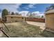 Large backyard featuring a grassy area, shed, brick home, and wood privacy fence at 1781 Uinta St, Denver, CO 80220
