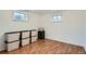 Basement room with two windows, laminate flooring and storage containers ready for use at 1781 Uinta St, Denver, CO 80220
