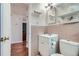 Small bathroom area featuring a white vanity, pink tile backsplash, and neutral walls at 1781 Uinta St, Denver, CO 80220