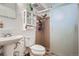 Bathroom with a sliding glass shower door and built-in shelving for convenient storage at 1781 Uinta St, Denver, CO 80220