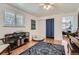 Comfortable bedroom with rug, hardwood floors, and natural light from multiple windows at 1781 Uinta St, Denver, CO 80220