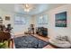 Sunlit bedroom with hardwood floors, ceiling fan, artwork, and multiple windows at 1781 Uinta St, Denver, CO 80220