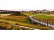 Scenic community view with walking path over a waterway with parks, landscaping and modern homes at 1781 Uinta St, Denver, CO 80220