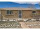 Well-maintained brick home featuring a secure screen door and landscaped front yard at 1781 Uinta St, Denver, CO 80220