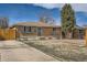 A charming brick house with well-kept landscaping, driveway, and fenced backyard at 1781 Uinta St, Denver, CO 80220