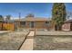 Charming home with manicured lawn, brick exterior, and inviting entrance at 1781 Uinta St, Denver, CO 80220