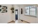 Bright kitchen area featuring tile floors, decorative shelves, wine rack and large window at 1781 Uinta St, Denver, CO 80220