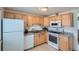 Functional kitchen featuring wooden cabinets, appliances, and plenty of storage space at 1781 Uinta St, Denver, CO 80220