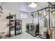 Functional laundry room with modern washer/dryer, utility sink, and storage shelves at 1781 Uinta St, Denver, CO 80220