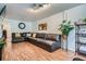 Spacious living room with an oversized leather couch, wood laminate floors, and tasteful decor at 1781 Uinta St, Denver, CO 80220