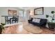 Inviting living room featuring hardwood floors, a dining area, and plenty of natural light at 1781 Uinta St, Denver, CO 80220