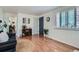 Cozy living room features wood floors, built in shelving, and large windows at 1781 Uinta St, Denver, CO 80220
