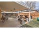 Covered patio with multiple grills, seating, and a fire pit for outdoor entertaining at 1781 Uinta St, Denver, CO 80220