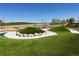 Community playground featuring grassy play mounds, a slide, and open spaces for recreational activities at 1781 Uinta St, Denver, CO 80220
