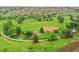 This aerial shot highlights a community park area and features a baseball field and scenic walking paths at 9246 Sori Ln, Highlands Ranch, CO 80126