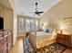 Comfortable bedroom with neutral walls, a ceiling fan, a large window, and hardwood floors at 9246 Sori Ln, Highlands Ranch, CO 80126
