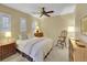 Comfortable bedroom with natural light, a ceiling fan, neutral walls, and a traditional bed at 9246 Sori Ln, Highlands Ranch, CO 80126