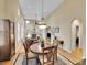 Elegant dining area adjacent to the living room, with hardwood floors and natural light at 9246 Sori Ln, Highlands Ranch, CO 80126