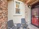 Charming front porch with seating area and decorative details and storm door at 9246 Sori Ln, Highlands Ranch, CO 80126