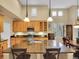 Bright kitchen showcasing a large island, wood cabinetry, and modern appliances at 9246 Sori Ln, Highlands Ranch, CO 80126