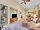 Open-concept living area with hardwood floors, and comfortable leather furniture and high ceilings at 9246 Sori Ln, Highlands Ranch, CO 80126
