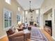 Cozy living room with a fireplace, large windows, and comfortable seating perfect for relaxing at 9246 Sori Ln, Highlands Ranch, CO 80126