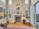 Bright living room featuring a fireplace, large windows, and hardwood floors, perfect for a cozy atmosphere at 9246 Sori Ln, Highlands Ranch, CO 80126