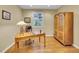Bright office space with hardwood floors, large desk, and built-in storage cabinet at 9246 Sori Ln, Highlands Ranch, CO 80126