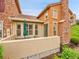 Private patio area featuring neutral colors, an umbrella, and brick accents, creating an inviting outdoor space at 9246 Sori Ln, Highlands Ranch, CO 80126