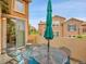 Relaxing outdoor patio with comfortable seating and a vibrant green umbrella, ideal for entertaining guests at 9246 Sori Ln, Highlands Ranch, CO 80126