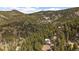 Aerial view of the property nestled among the trees and mountains at 960 Aspen Pl, Evergreen, CO 80439