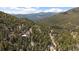 Scenic aerial view of a home nestled among trees, boasting beautiful mountain views at 960 Aspen Pl, Evergreen, CO 80439