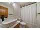 Bathroom featuring a wooden vanity and tub with shower at 960 Aspen Pl, Evergreen, CO 80439
