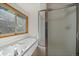 Bathroom featuring a tub and glass-enclosed shower at 960 Aspen Pl, Evergreen, CO 80439