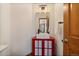 Bathroom with white sink and unique red cabinet below plus a matching-framed mirror and dark wood door at 960 Aspen Pl, Evergreen, CO 80439