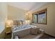Bedroom with a large bed, and large window with views of the mountains from the attached balcony at 960 Aspen Pl, Evergreen, CO 80439