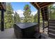 Deck featuring covered hot tub with mountain views at 960 Aspen Pl, Evergreen, CO 80439