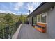 Relax on this deck with a storage bench and a lovely wooded view at 960 Aspen Pl, Evergreen, CO 80439