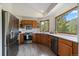 Spacious kitchen features wood cabinets, stainless steel appliances, solid countertops, and natural light at 960 Aspen Pl, Evergreen, CO 80439