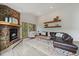 The living room features a stone fireplace, hardwood floors, and a leather sofa at 960 Aspen Pl, Evergreen, CO 80439