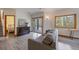 Second living room features wood flooring, neutral walls, a sliding glass door, and a large window at 960 Aspen Pl, Evergreen, CO 80439