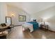 The main bedroom features hardwood floors, a seating area, and a window at 960 Aspen Pl, Evergreen, CO 80439