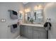 Bathroom features a double vanity with marble countertops, decorative mirrors, and modern lighting at 21142 Hawthorne Ln, Parker, CO 80138