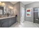 Bathroom featuring a double vanity with marble countertop, decorative mirrors and modern lighting at 21142 Hawthorne Ln, Parker, CO 80138