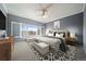 Serene main bedroom features a comfortable seating area, plantation shutters and soft carpet flooring at 21142 Hawthorne Ln, Parker, CO 80138