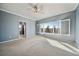 Spacious primary bedroom features a ceiling fan and large windows for natural light and neighborhood views at 21142 Hawthorne Ln, Parker, CO 80138