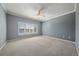 Bright bedroom features neutral walls, plush carpeting, a ceiling fan, and a large window at 21142 Hawthorne Ln, Parker, CO 80138