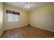 Inviting bedroom with hardwood floors, a ceiling fan, and a window at 21142 Hawthorne Ln, Parker, CO 80138